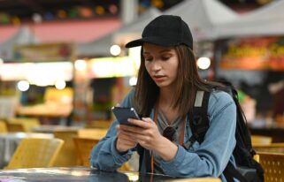 Beautiful caucasian young woman messaging on smart phone