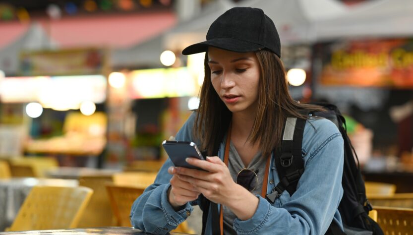 Beautiful caucasian young woman messaging on smart phone
